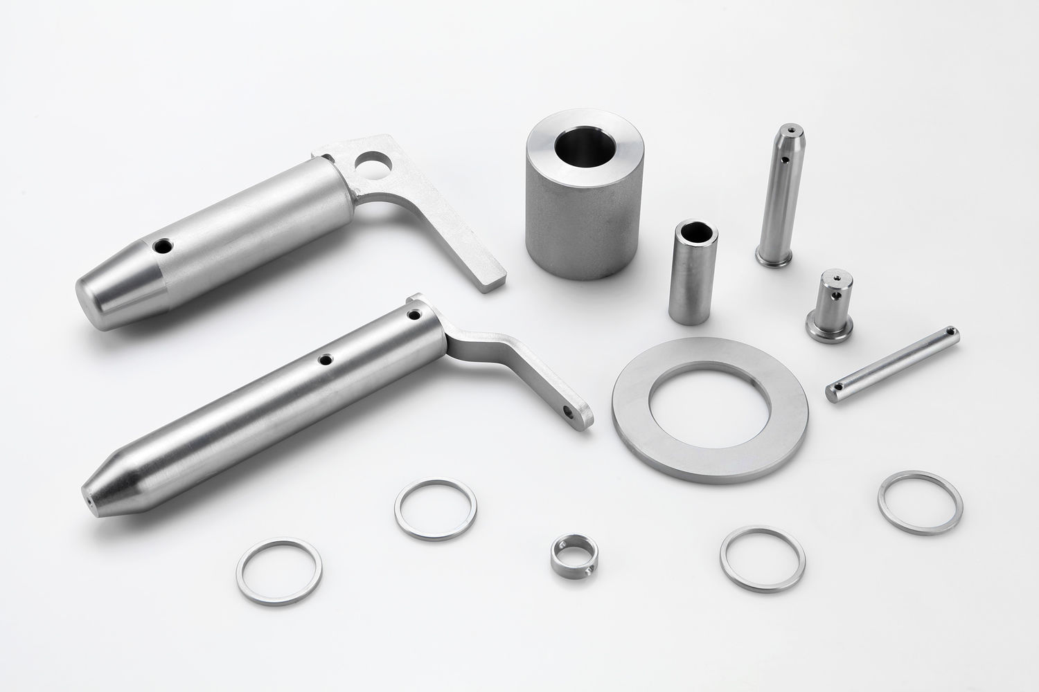 Metal parts with a white finish, zinc nickel layer plus a transparent-iridescent passivation and sealant for improved corrosion resistance.